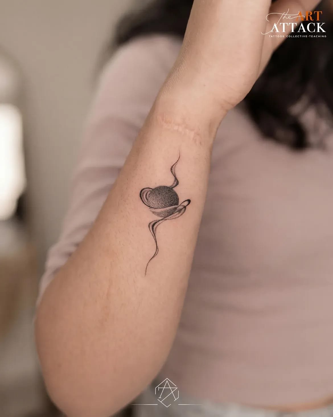 Small fine-line sun, moon and stars tattooed along a collarbone.