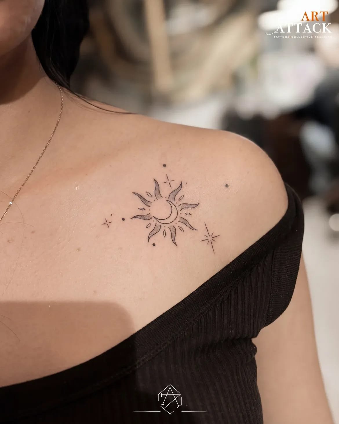 Delicate dandelion tattooed on a shoulder in fine black line work.